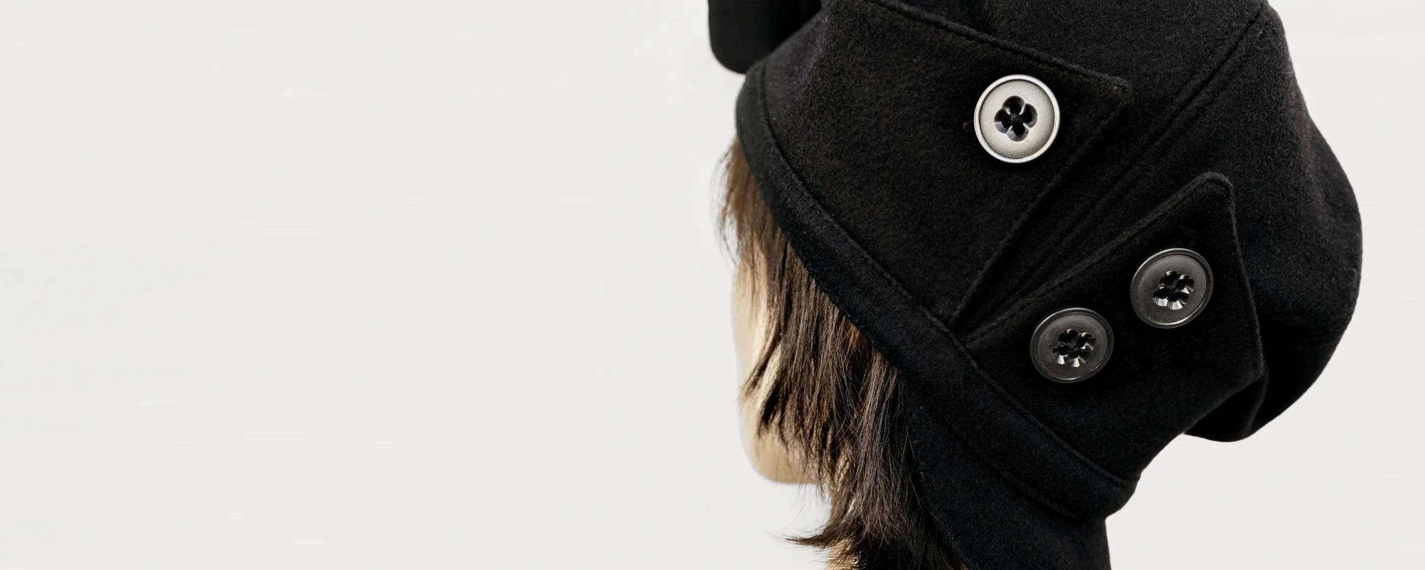 Close-up of the PETAL beret wool texture and buttons