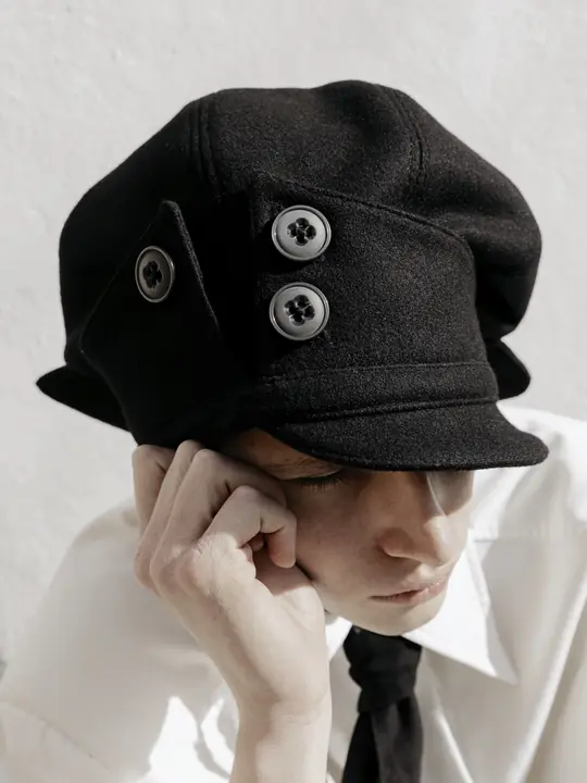 Close-up of PETAL beret button detailing
