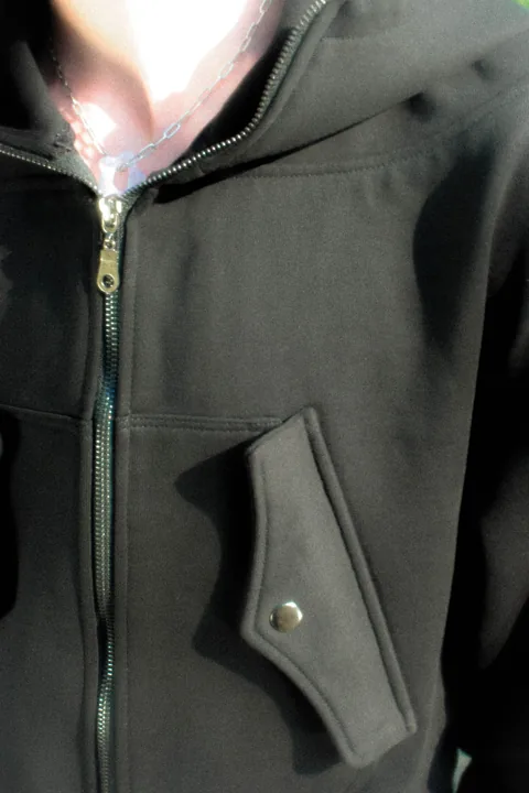 Close detail of the KEY hoodie zipper and collar